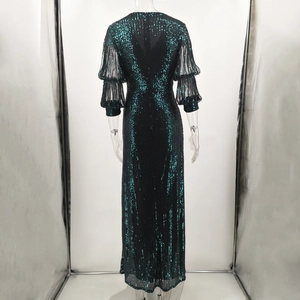 Detail view of emerald green and black sequin gown featuring layered lantern sleeves