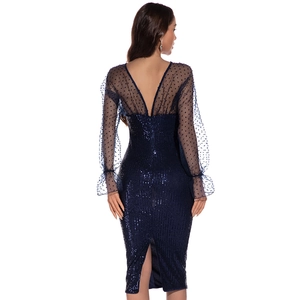 Detail of navy blue sequin dress with backless design and polka dot mesh sleeves