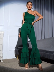 Detail of dark green one-shoulder jumpsuit with ruffled tiered hems and waist tie belt
