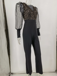 Detail of sequined mesh bodice and sheer puff sleeves on this black women jumpsuit