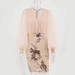Detail of sequin floral embroidery and sheer mesh puff sleeves on a pink party dress