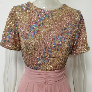 Close-up of golden sequin embroidery with floral patterns and pink chiffon waistband