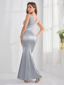 Detailed view of back V-neck and glossy silver satin texture on mermaid dress