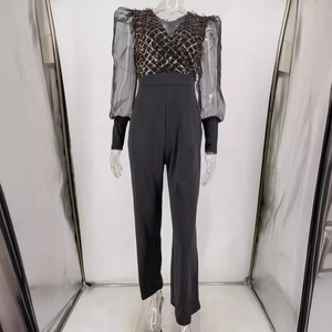 Elegant black jumpsuit with golden sequin V-neck and sheer mesh puff sleeves