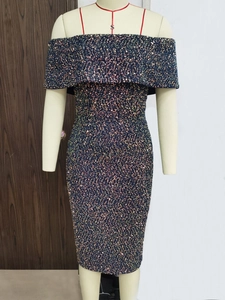 Detail of green sequin dress featuring off-shoulder fold and thin red shoulder straps