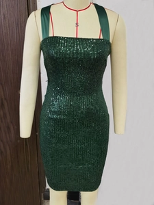 Détail de paillettes vert vintage sur une robe ajustée avec motif vertical scintillant