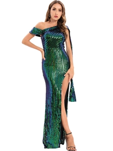 Detail of green sequin gown showing one-shoulder cape sleeve and side high slit