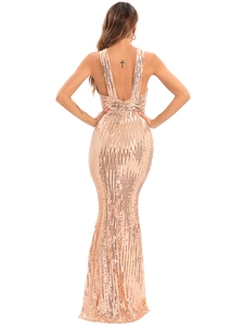 Detail of cross-back straps on a sequined backless evening gown in champagne gold