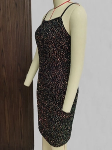 Detailed view of shimmering multi-color sequins on a black bodycon camisole dress