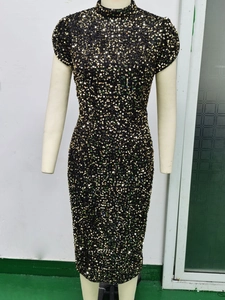 Detailed view of shimmering sequins on black bodycon mini dress with half turtleneck