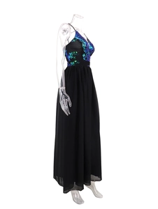 Detail of V-neck sequined bodice and flowing black chiffon skirt of the backless dress