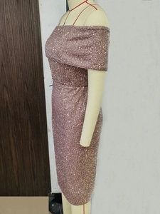 Detail of sequined off-shoulder cocktail dress showing rose gold metallic texture