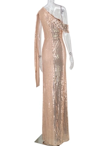 Macro shot of rose gold sequins on a one-shoulder evening gown with shimmering metallic texture