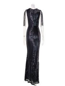 Close-up of black sequins texture and fringe shoulder details on elegant evening dress