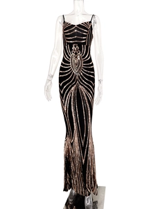 Detailed view of glamorous gold sequins and geometric patterns on a black evening gown