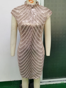 Detailed view of rose gold sequin mini dress with geometric V-shaped pattern fabric