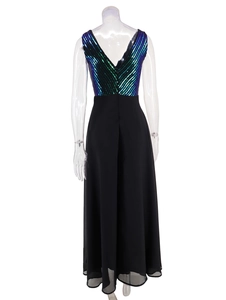 Detail of evening dress featuring V-back cut with dark sequins and black chiffon skirt