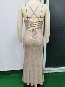 Détail d'une robe à paillettes champagne avec dos nu et bretelles croisées à lacets
