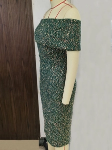 Close-up of high-density sequins and off-the-shoulder detail on a dark green party dress