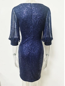Détail de la robe à paillettes bleu marine avec manches à franges et coupe ajustée