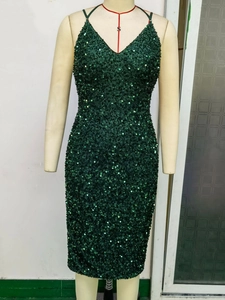 Detailed view of the dark green sequins and V-neckline on the backless dress