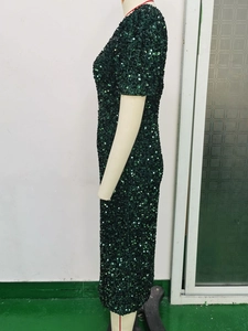 Detailed close-up showing the shimmering dark green sequins on this retro evening dress