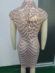 Detailed back view of a champagne sequin bodycon dress with wavy texture on a mannequin