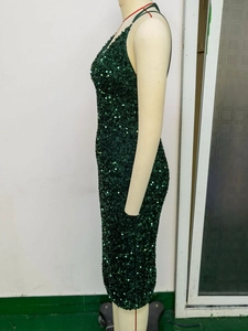 Close-up of the shimmering dark green sequins and side fit of the backless dress