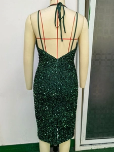 Detail of cross straps and open back design on this dark green sequin evening dress
