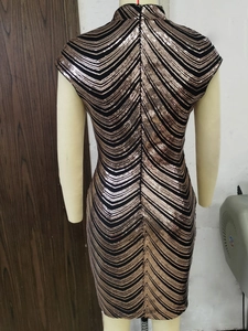 Close-up of the high neck sequined dress with dynamic golden wave patterns