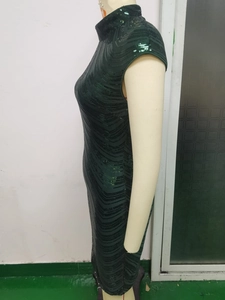 Detailed side view of dark green sequin gown with elegant wavy textures and slim fit design