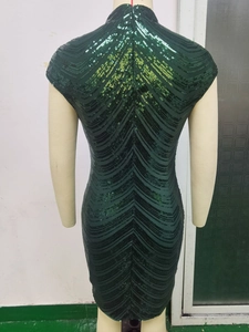 Detail of dark green sequin dress back with V-shaped pattern and hidden zipper
