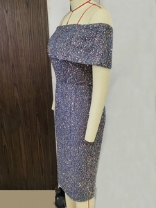 Detail shot of shimmering dark purple sequins on an elegant off-the-shoulder midi dress