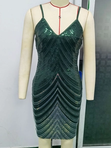Detail of emerald green sequin dress with deep V-neck and sparkling chevron patterns