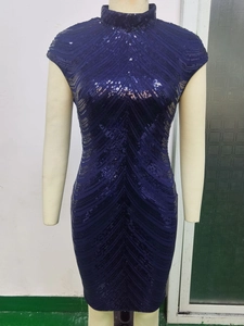 Detailed view of dark blue sequin dress with V-shaped texture and high neckline
