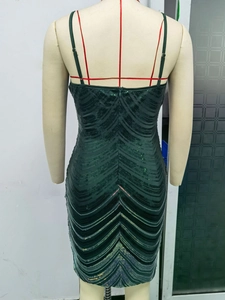 Detailed view of dark green sequin dress with V-wave pattern and back zipper closure