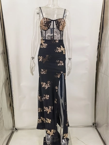 Detail of corset bodice with gold floral sequin embroidery on black evening dress