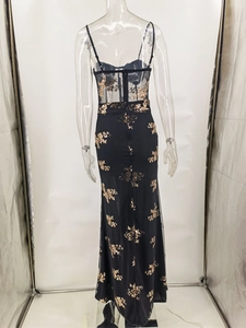 Detail of sheer mesh bodice with boning and gold sequin floral embroidery on black dress