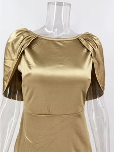 Detail of champagne gold satin evening dress showing pleated cape sleeves and silky texture