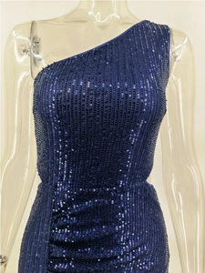 Close-up of deep blue sequins on a one-shoulder evening dress with vertical stripe patterns