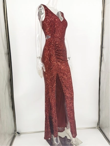 Détail d'une robe de soirée rouge à paillettes avec découpe latérale et fente haute
