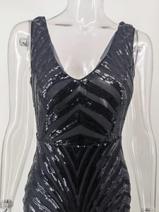 Close-up of black sequined evening dress with deep V-neck and geometric patterns