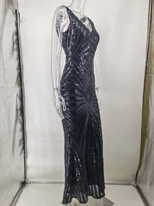 Detail of black sequined evening gown with geometric stripes and deep V-neckline