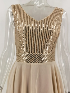 Detail of V-neck champagne gold sequin bodice and flowing chiffon skirt on a dress