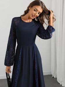 Detailed view of dark blue lace floral patchwork on sheer sleeves and elegant chiffon hem