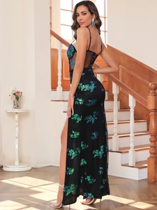 Detail of sheer mesh back and teal sequin floral embroidery on a black evening gown