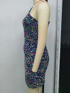 Close-up of colorful sequins and side texture on a backless long sleeve mini dress