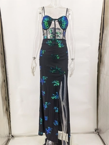 Close-up of see-through mesh top with sequins and thigh-high slit on a black dress