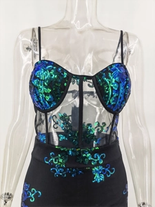 Detailed view of corset bodice with blue sequins and sheer mesh on a black dress