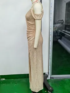 Detail of champagne gold sequin evening gown showing cold-shoulder and high side slit